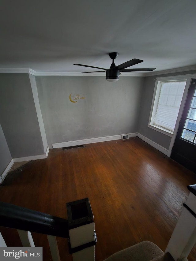 unfurnished room with dark hardwood / wood-style floors, ceiling fan, and ornamental molding