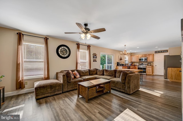 living room featuring dark hardwood / wood-style floors and ceiling fan with notable chandelier