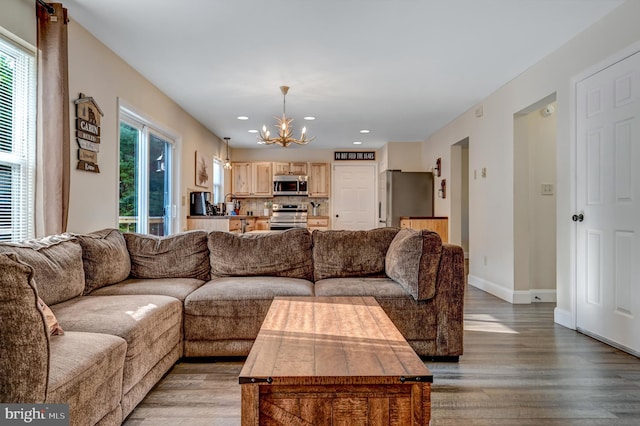 living room featuring light hardwood / wood-style floors and a chandelier