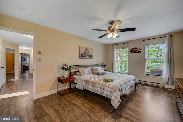 bedroom featuring ceiling fan, baseboard heating, and dark wood-type flooring