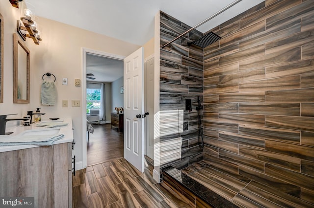 bathroom featuring vanity, a shower, and wood-type flooring