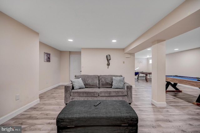 living room with light hardwood / wood-style flooring and billiards