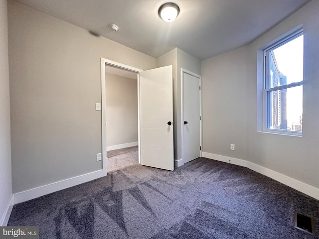 unfurnished bedroom with carpet and a closet