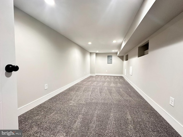 basement featuring electric panel and carpet