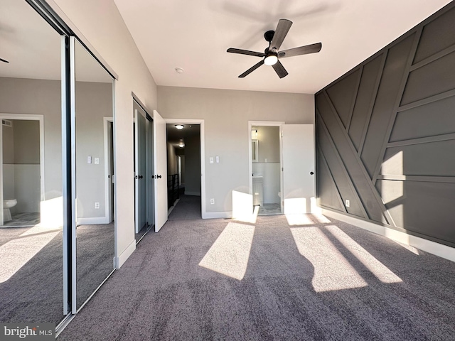 unfurnished bedroom featuring carpet flooring, ensuite bathroom, and ceiling fan