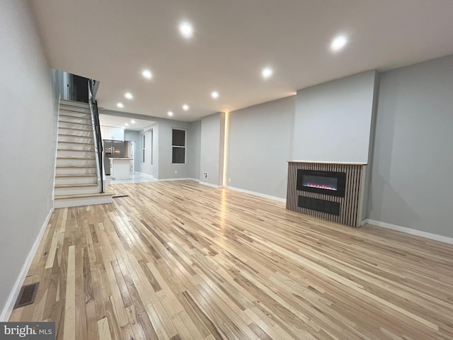 unfurnished living room featuring light hardwood / wood-style flooring