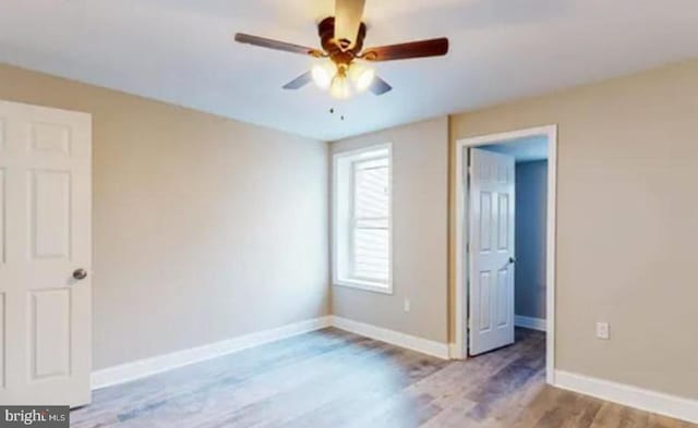 unfurnished bedroom with light wood-type flooring and ceiling fan