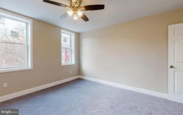 carpeted spare room with plenty of natural light and ceiling fan