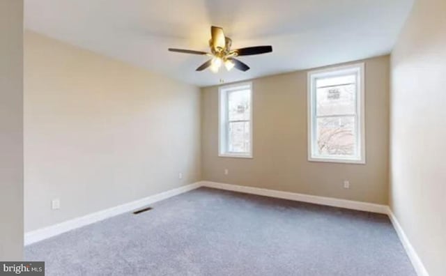 empty room featuring carpet and ceiling fan