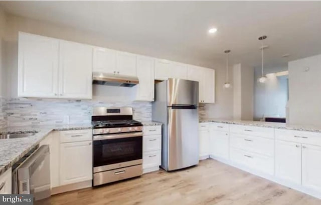 kitchen with white cabinetry, hanging light fixtures, light hardwood / wood-style floors, and appliances with stainless steel finishes