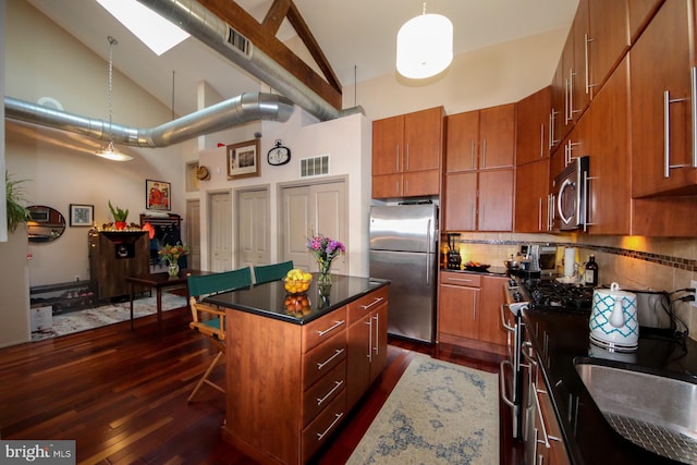 kitchen featuring dark wood-type flooring, high vaulted ceiling, tasteful backsplash, a kitchen island, and stainless steel appliances