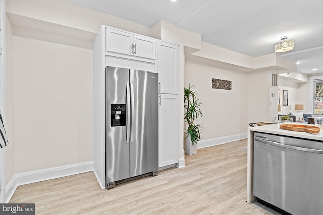 kitchen featuring white cabinetry, light hardwood / wood-style floors, and appliances with stainless steel finishes