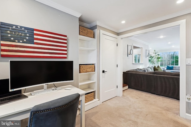 office space with built in desk, light colored carpet, and crown molding