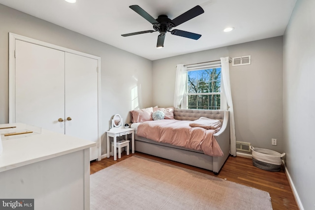 bedroom featuring wood-type flooring, a closet, and ceiling fan