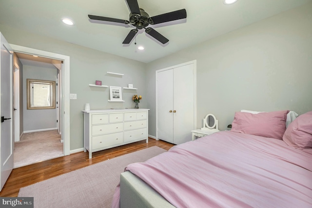 bedroom featuring ceiling fan, wood-type flooring, and a closet