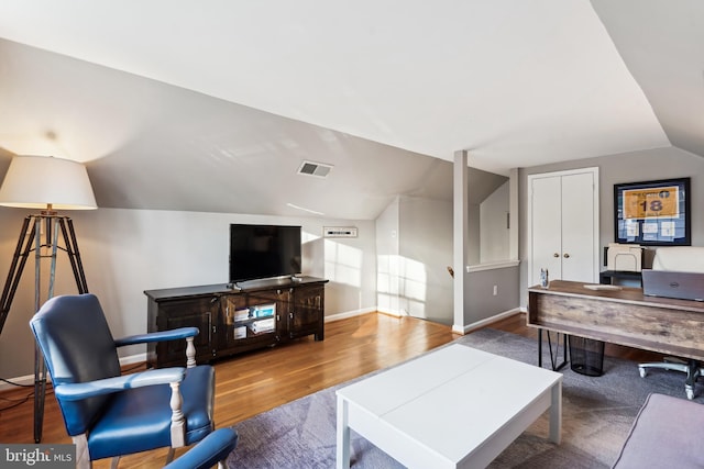 living room featuring wood-type flooring and lofted ceiling