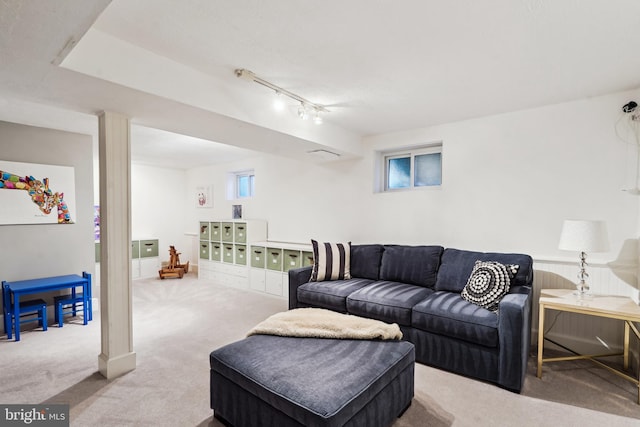 carpeted living room with rail lighting