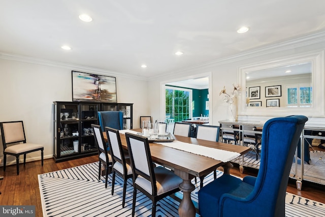 dining area featuring crown molding and dark wood-type flooring