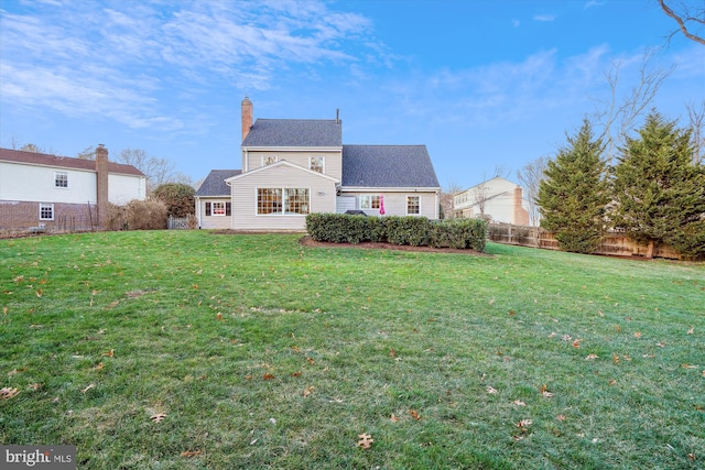 rear view of house with a yard