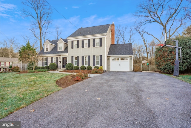 view of front facade featuring a front yard and a garage