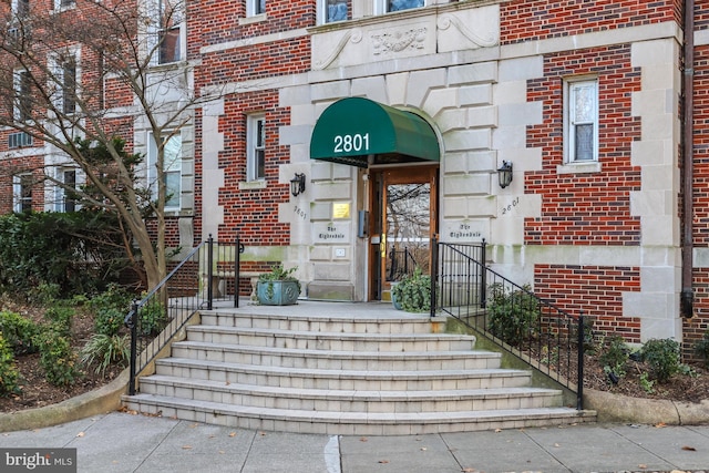 property entrance featuring brick siding