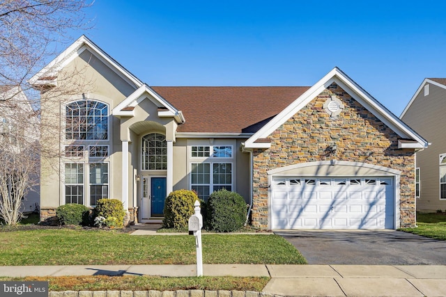 view of front facade featuring a front yard and a garage