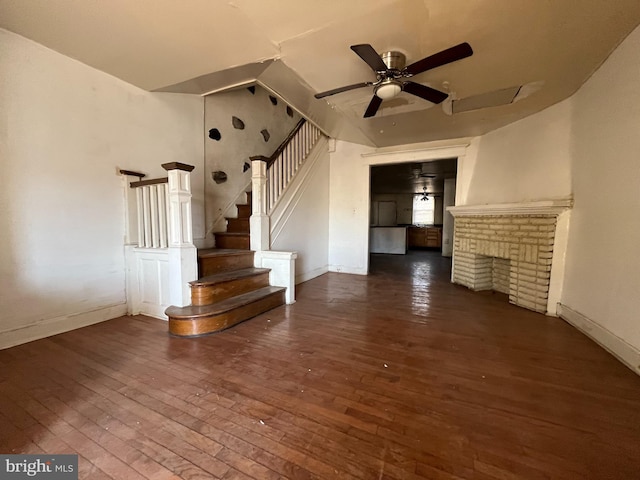 unfurnished living room featuring lofted ceiling, ceiling fan, a fireplace, and dark hardwood / wood-style floors