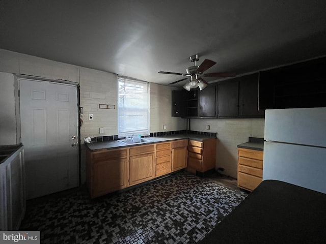 kitchen with white fridge, ceiling fan, and sink