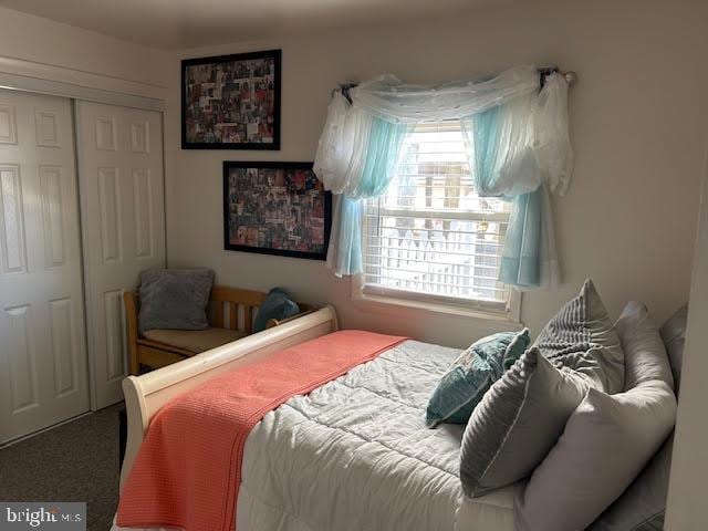 carpeted bedroom with a closet