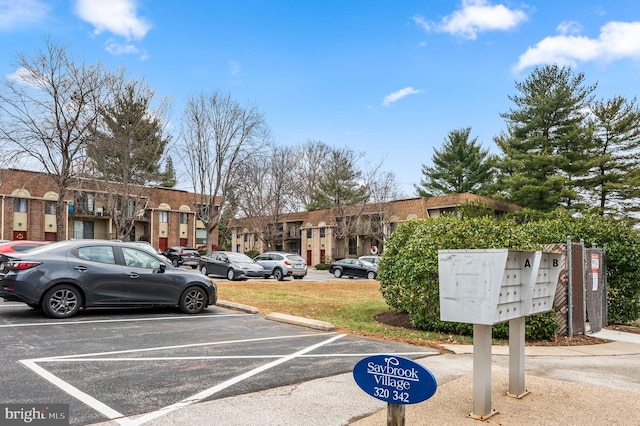 view of car parking with a mail area