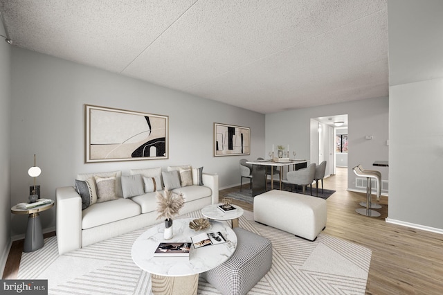 living room featuring a textured ceiling and hardwood / wood-style flooring