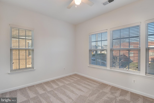 spare room featuring carpet flooring and ceiling fan