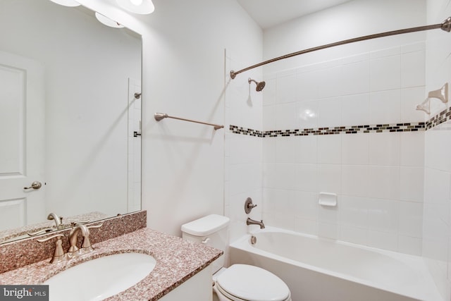 full bathroom with vanity, toilet, and tiled shower / bath combo