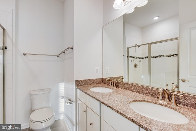 bathroom with tile patterned floors, vanity, toilet, and an enclosed shower