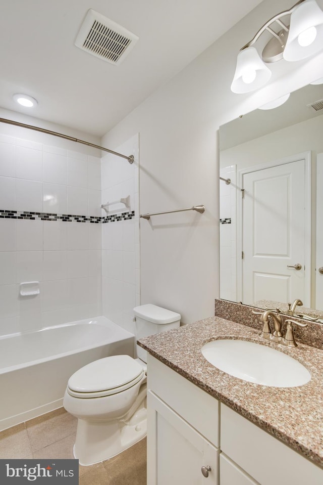 full bathroom featuring tile patterned flooring, vanity, toilet, and tiled shower / bath combo