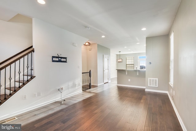 unfurnished living room with hardwood / wood-style flooring