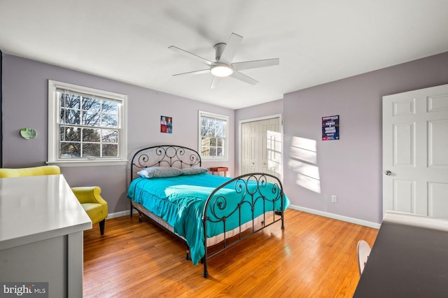 bedroom featuring ceiling fan, a closet, and light hardwood / wood-style floors