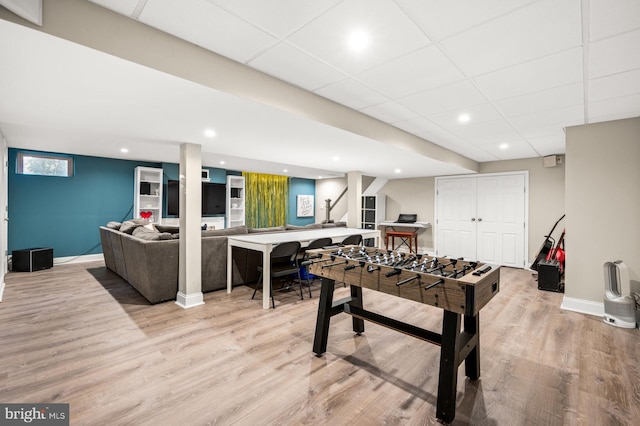 playroom featuring a drop ceiling and light hardwood / wood-style floors