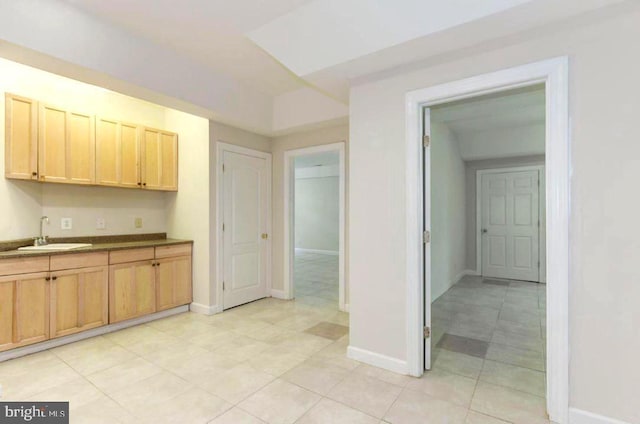 6614 Quander Rd, Alexandria, VA 22307 - kitchen featuring light brown cabinets, light tile patterned floors, and sink