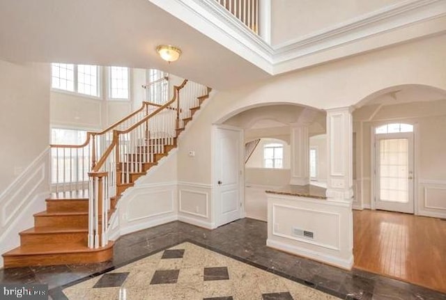 6614 Quander Rd, Alexandria, VA 22307 - entrance foyer featuring plenty of natural light, dark hardwood / wood-style floors, a towering ceiling, and ornate columns