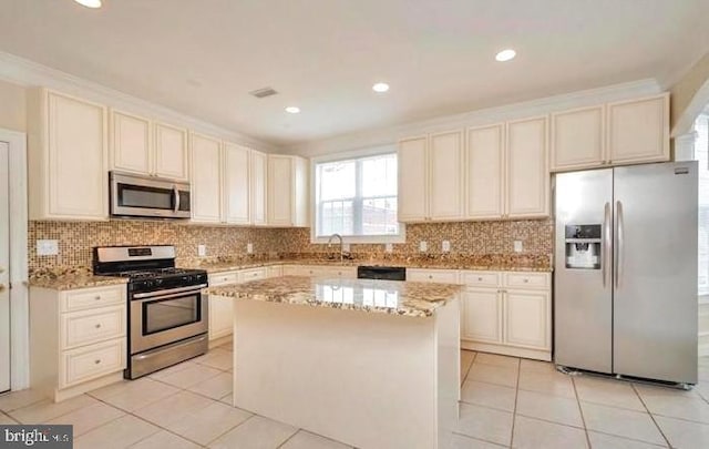 6614 Quander Rd, Alexandria, VA 22307 - kitchen with a center island, stainless steel appliances, light stone counters, and light tile patterned flooring