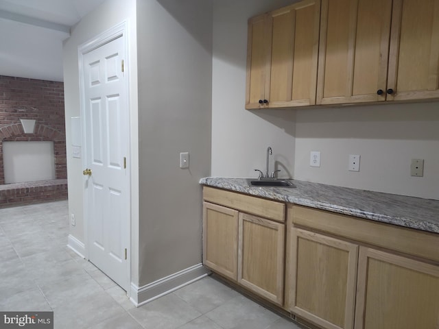 6614 Quander Rd, Alexandria, VA 22307 - kitchen featuring light tile patterned floors, sink, and brick wall
