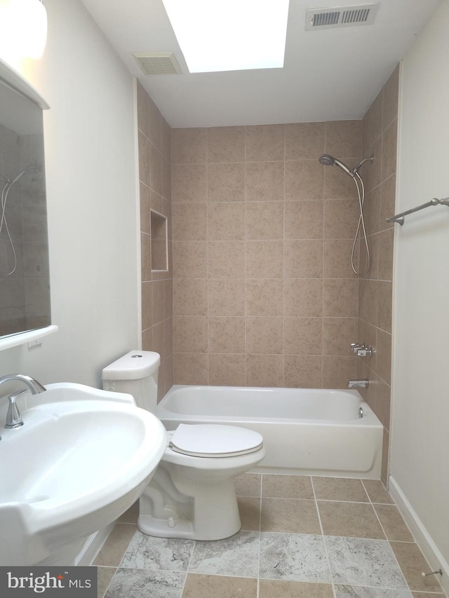 6614 Quander Rd, Alexandria, VA 22307 - full bathroom with a skylight, sink, toilet, and tiled shower / bath