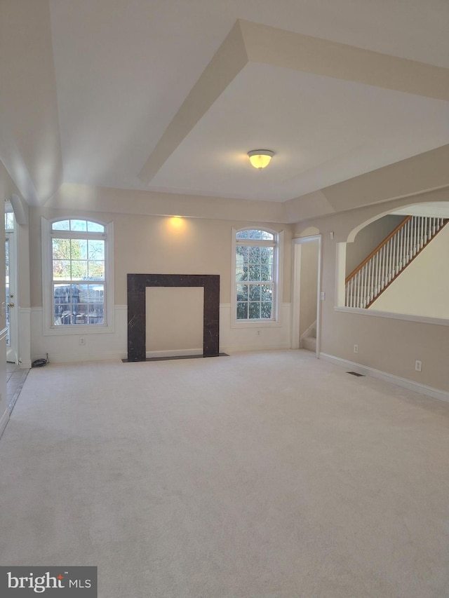 6614 Quander Rd, Alexandria, VA 22307 - unfurnished living room featuring a high end fireplace and light colored carpet