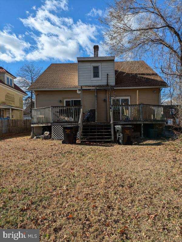 back of house with a lawn and a wooden deck