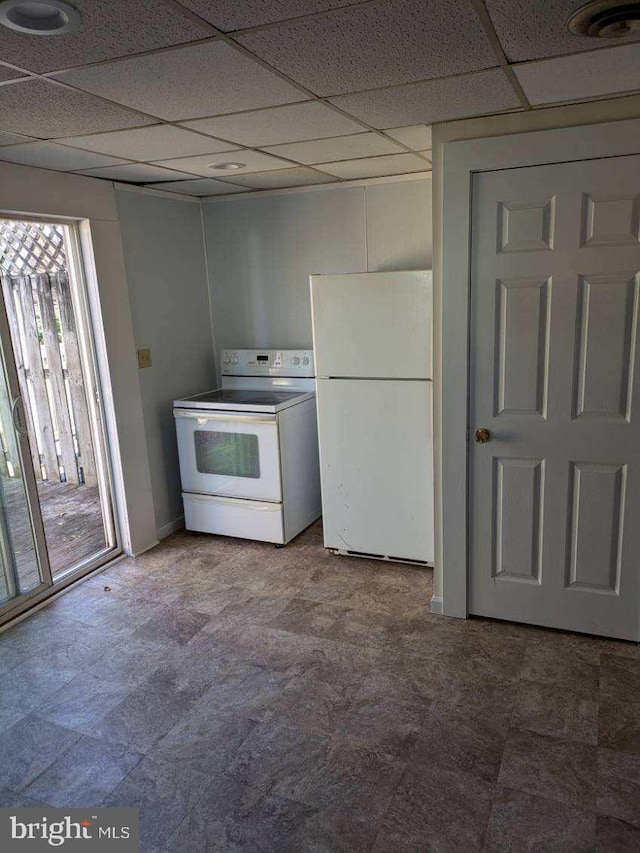 kitchen with white appliances and a paneled ceiling