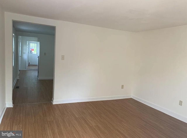 unfurnished room with dark hardwood / wood-style floors