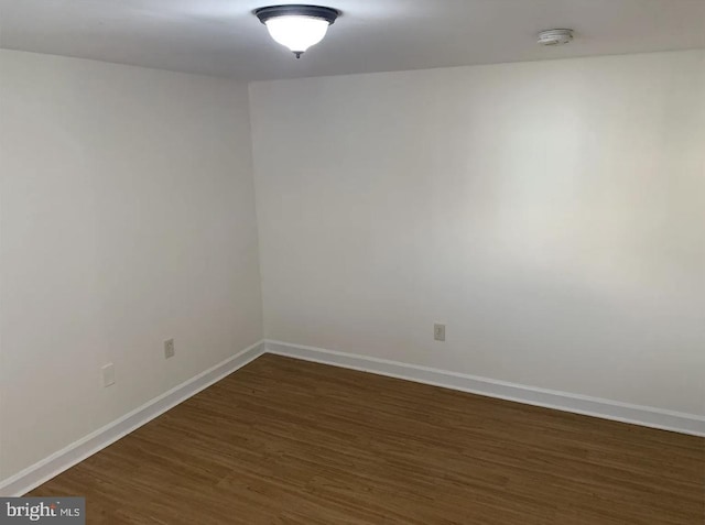 unfurnished room featuring dark wood-type flooring