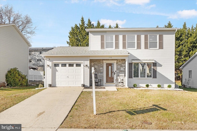 view of front property featuring a front lawn and a garage