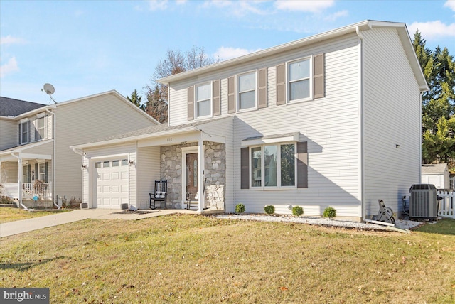 view of front property featuring cooling unit, a garage, and a front yard